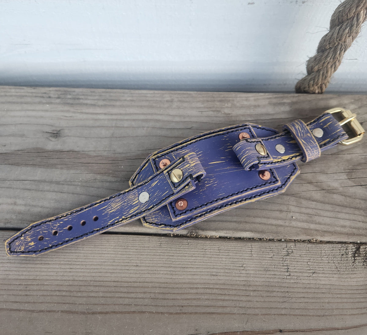 Blue distressed leather watch band on wood
